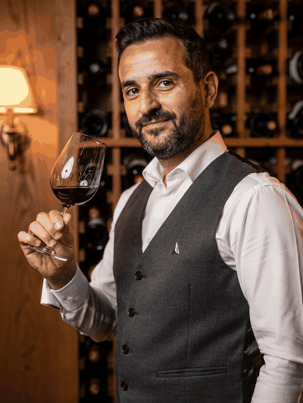 Portrait of Head Sommelier Luca Moretti in the wine cellar